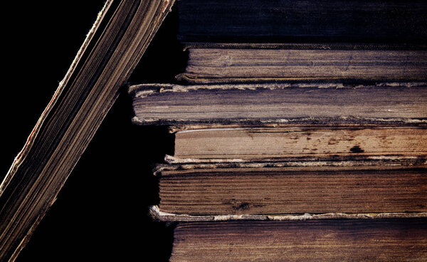 Old messy books on the black background.