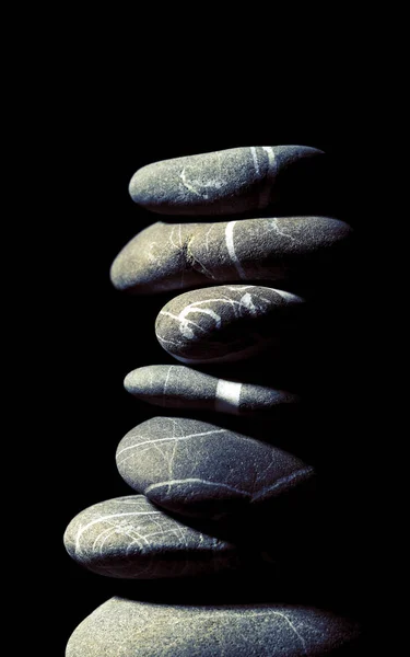 Tower of stones on the black background — Stock Photo, Image