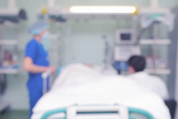 People at the patient bed, unfocused background — Stock Photo, Image