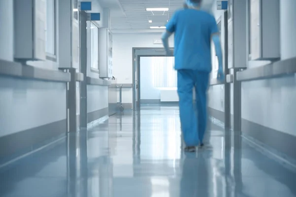 Doctor walking on hospital hallway — Stock Photo, Image