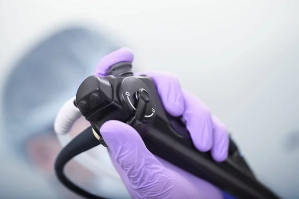 Bronchoscope in the doctor's hand during the procedure — Stock Photo, Image