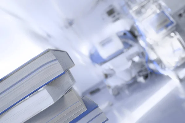 Stack of books on the background of patient bed — Stock Photo, Image