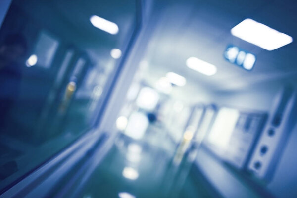 Blurred view of a hospital department with reflection of female 