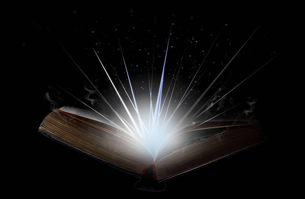 Open book with flash of light, magical smoke and glitter in the air.