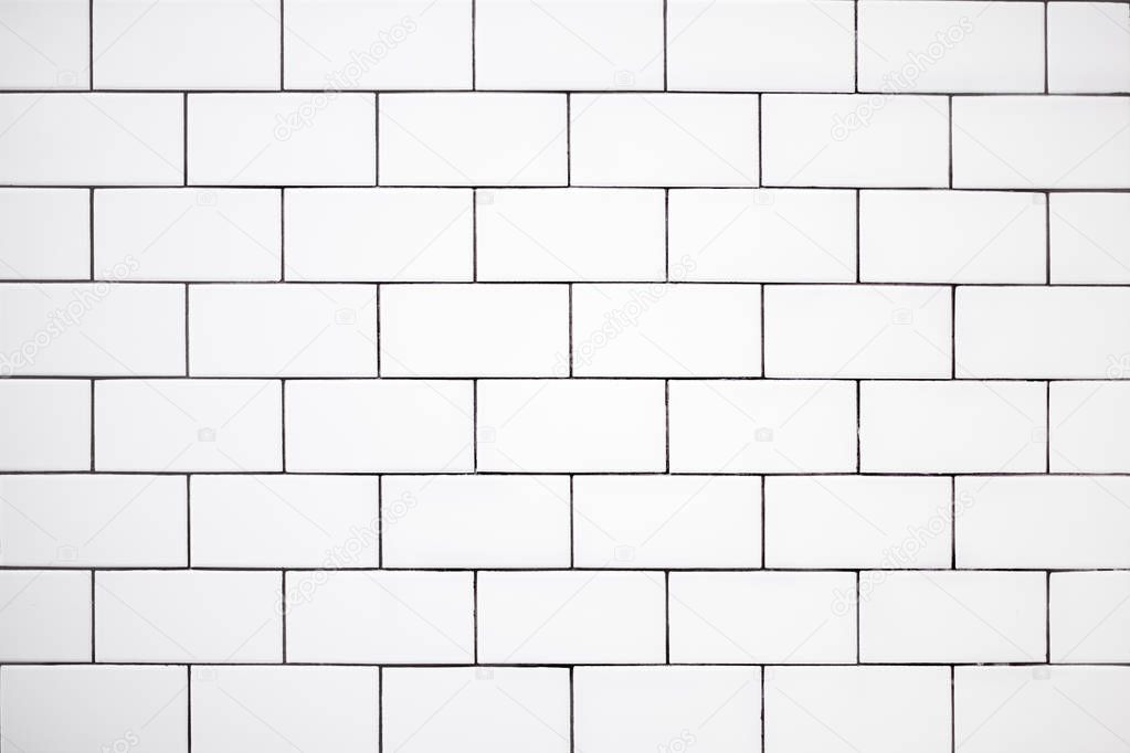 white classic ceramic tiles on the wall in the bathroom, brick tiles, background