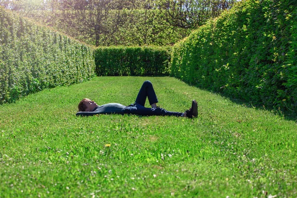 Boy Lies His Back Green Grass Trimmed Lawn Rest School — Stock Photo, Image