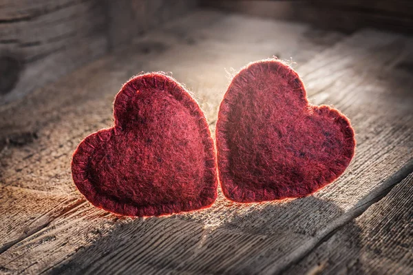 2 texture hearts on an old wooden table, background for Valentine\'s Day, card for Valentine\'s Day