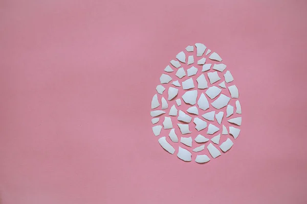 Beyaz Yumurta Kabuğu Parçaları Pembe Arka Planda Yumurta Şeklinde Katlanmış — Stok fotoğraf
