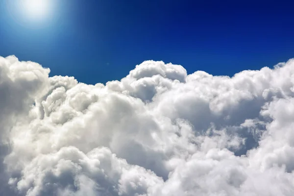 Cloudscape. Blue sky and white cloud. Sunny day. Cumulus clouds Beautiful blue sky and white fluffy clouds for background, view sky from an airplane