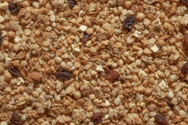 Mısır gevreği, fındıklı, kuru üzümlü ve meyveli çekirdeklerin arka planı, yakın plan. Sağlıklı kahvaltı kavramı