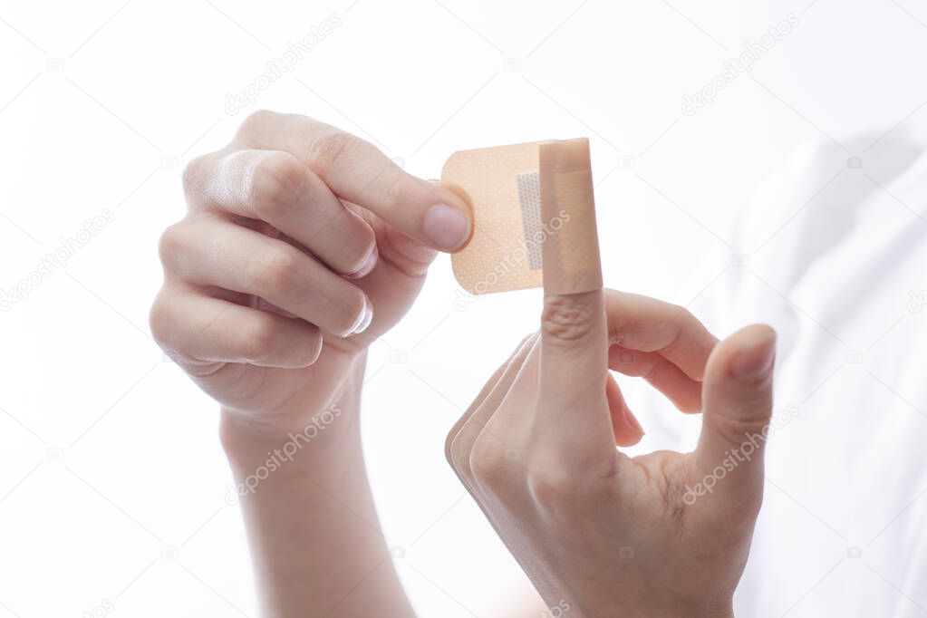 band-aid on the index finger, isolate, first aid for small wounds, cuts, scratches, treatment and disinfection of wounds