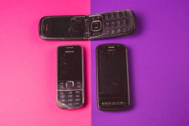 Saint-Petersburg, Rusya - 03 Mart 2020: Farklı eski eski kazı kazınmış grup 2000 'lerden kalma pembe menekşe üzerine nokia cep telefonu nokia qwerty kullanıldı. İllüstrasyon Editörü