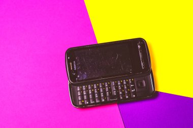 Saint-Petersburg, Rusya - 03 Mart 2020: Pembe menekşe arkaplan üzerinde eski siyah vintage cep telefonu nokia qwerty. İllüstrasyon Editörü