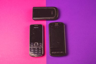 Saint-Petersburg, Rusya - 03 Mart 2020: Farklı eski eski kazı kazınmış grup 2000 'lerden kalma pembe menekşe üzerine nokia cep telefonu nokia qwerty kullanıldı. İllüstrasyon Editörü