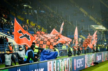 KHARKIV, UKRAINE - December 11, 2019: Flags in support of FC Shakhtar Donetsk with the team colors during the UEFA Champions League match between Shakhtar vs Atalanta BC (Italy), Ukraine