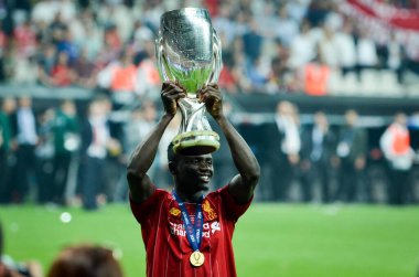 Istanbul, Turkey - August 14, 2019: Sadio Mane celebrates victory holding in his hands UEFA Super Cup after the match between Liverpool and Chelsea at Vodafone Park in Vodafone Arena, Turkey