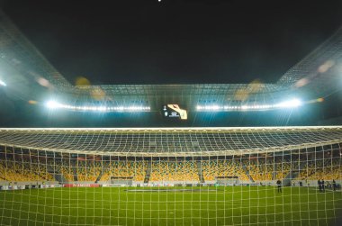LVIV, UKRAINE - November 07, 2019: Night football stadium close up behind the gate during the UEFA Europa League match between Alexandria (Ukraine) vs AS Saint Etienne (France), Ukraine