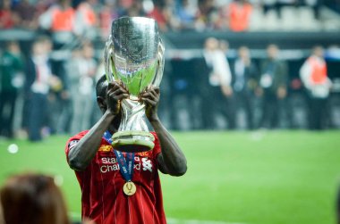 Istanbul, Turkey - August 14, 2019: Sadio Mane celebrates victory holding in his hands UEFA Super Cup after the match between Liverpool and Chelsea at Vodafone Park in Vodafone Arena, Turkey