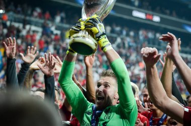 Istanbul, Turkey - August 14, 2019: Adrian celebrate victory and hold trophy UEFA Super Cup at Vodafone Park in Vodafone Arena, Turkey