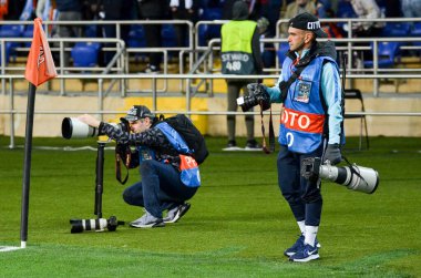 KHARKIV, UKRAINE - September 18, 2019: Photographers make a report with cameras and lenses during the UEFA Champions League match, Ukraine