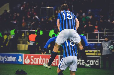 KHARKIV, UKRAINE - December 11, 2019: Marten de Roon and Ruslan Malinovskyi celebrate goal scored  during the UEFA Champions League match between Shakhtar vs Atalanta BC (Italy), Ukraine