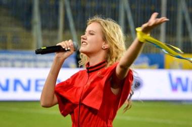 DNIPRO, UKRAINE - September 10, 2019: Singer and beautiful girl emotionally performs at the stadium during the friendly match between national team Ukraine against Nigeria, Ukraine