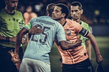 KHARKIV, UKRAINE - September 18, 2019: Fernandinho and Taison hugging during the UEFA Champions League match between Shakhtar Donetsk vs Manchester City (England), Ukraine