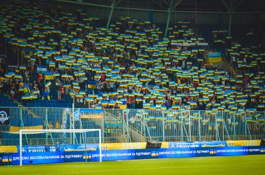 DNIPRO, UKRAINE - September 10, 2019: Ukrainian fans and spectators support team on the stadium player during the friendly match between national team Ukraine against Nigeria, Ukraine