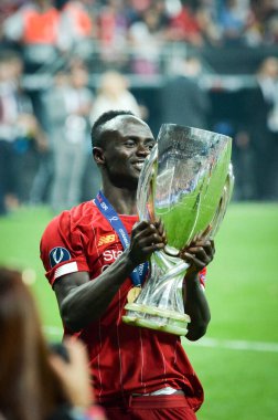 Istanbul, Turkey - August 14, 2019: Sadio Mane celebrates victory holding in his hands UEFA Super Cup after the match between Liverpool and Chelsea at Vodafone Park in Vodafone Arena, Turkey