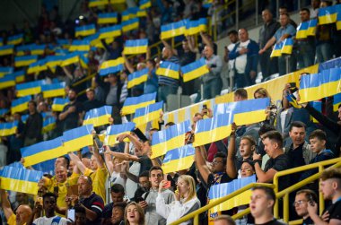 DNIPRO, UKRAINE - September 10, 2019: Ukrainian fans and spectators support team on the stadium player during the friendly match between national team Ukraine against Nigeria, Ukraine