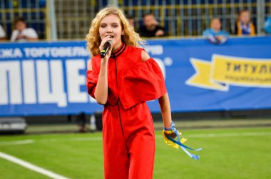 DNIPRO, UKRAINE - September 10, 2019: Singer and beautiful girl emotionally performs at the stadium during the friendly match between national team Ukraine against Nigeria, Ukraine