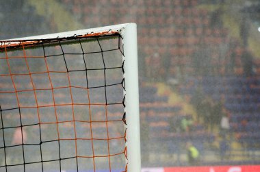 KHARKIV, UKRAINE - September 18, 2019: Football gate closeup on the background of rain and watering the lawn during the UEFA Champions League match, Ukraine