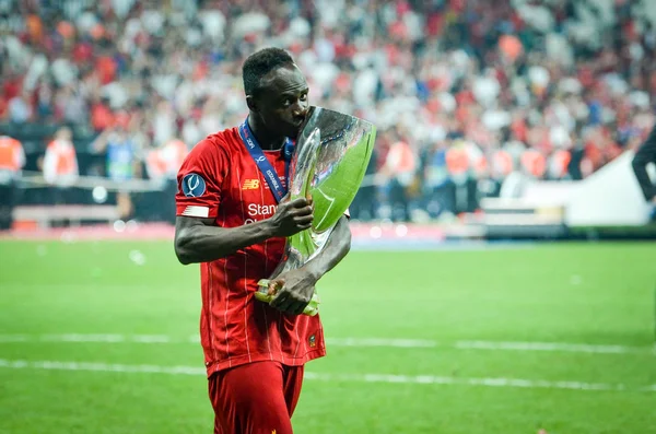 Istanbul, Turkey - August 14, 2019: Sadio Mane celebrates victory holding in his hands UEFA Super Cup after the match between Liverpool and Chelsea at Vodafone Park in Vodafone Arena, Turkey