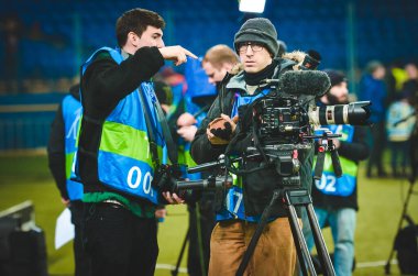 KHARKIV, UKRAINE - December 11, 2019: TV Videographer with camera during the UEFA Champions League match between Shakhtar vs Atalanta BC (Italy), Ukraine