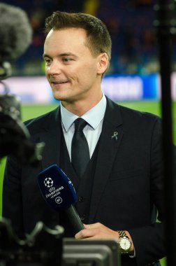 KHARKIV, UKRAINE - September 18, 2019: A journalist with a microphone makes a report  on the camera during the UEFA Champions League match, Ukraine