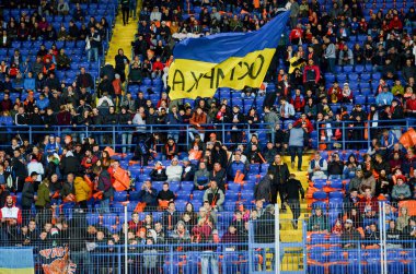 KHARKIV, UKRAINE - September 18, 2019: Football fans on the stadium support the team during the UEFA Champions League match,  Ukraine