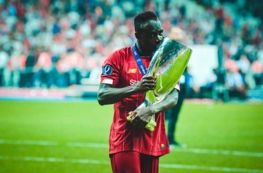 Istanbul, Turkey - August 14, 2019: Sadio Mane celebrates victory holding in his hands UEFA Super Cup after the match between Liverpool and Chelsea at Vodafone Park in Vodafone Arena, Turkey