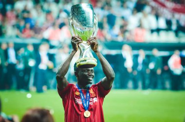 Istanbul, Turkey - August 14, 2019: Sadio Mane celebrates victory holding in his hands UEFA Super Cup after the match between Liverpool and Chelsea at Vodafone Park in Vodafone Arena, Turkey