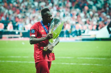 Istanbul, Turkey - August 14, 2019: Sadio Mane celebrates victory holding in his hands UEFA Super Cup after the match between Liverpool and Chelsea at Vodafone Park in Vodafone Arena, Turkey