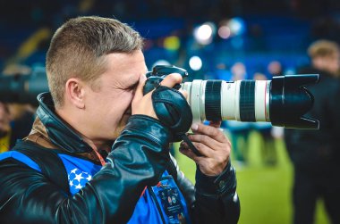 KHARKIV, UKRAINE - September 18, 2019: Journalists and photographers with a camera make report during the UEFA Champions League match, Ukraine