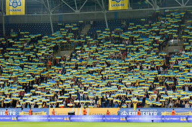 DNIPRO, UKRAINE - September 10, 2019: Ukrainian fans and spectators support team on the stadium player during the friendly match between national team Ukraine against Nigeria, Ukraine