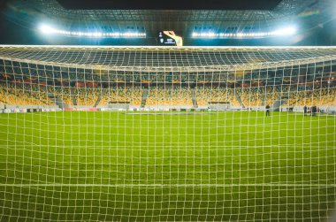 LVIV, UKRAINE - November 07, 2019: Night football stadium close up behind the gate during the UEFA Europa League match between Alexandria (Ukraine) vs AS Saint Etienne (France), Ukraine