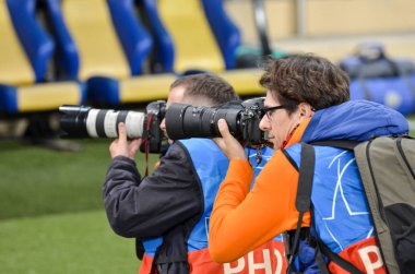 KHARKIV, UKRAINE - September 18, 2019: Journalists and photographers with a camera make report during the UEFA Champions League match, Ukraine