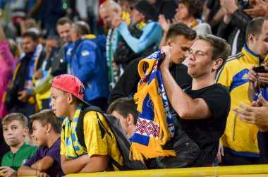 DNIPRO, UKRAINE - September 10, 2019: Football fans and spectators support the team during the friendly match between national team Ukraine against Nigeria, Ukraine