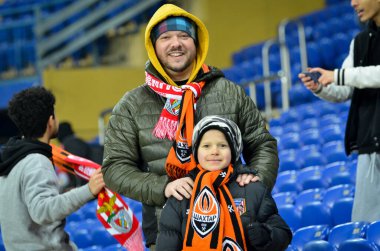 KHARKIV, UKRAINE - Febriary 20, 2020: Football fans on the stadium support theit team during the UEFA Europe League match between Shakhtar vs SL Benfica, Ukraine