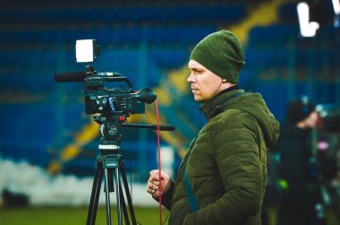 KHARKIV, UKRAINE - Febriary 20, 2020: Operator with camera during the UEFA Europe League match between Shakhtar Donetsk vs SL Benfica (Portugal), Ukraine