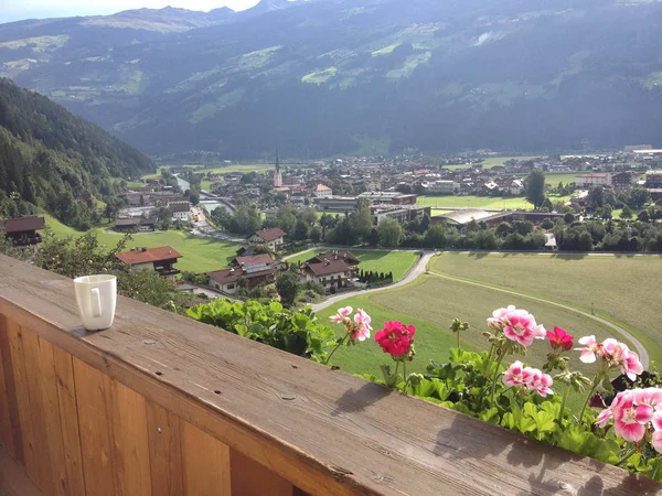Austrian Alps, summer landscape from the balcony of an Austrian chalet and a cup on the railing