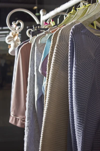 Knitted homemade clothes of different colors hanging on a hanger — Φωτογραφία Αρχείου