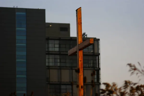 faith sign cross, against the backdrop of a housing estate