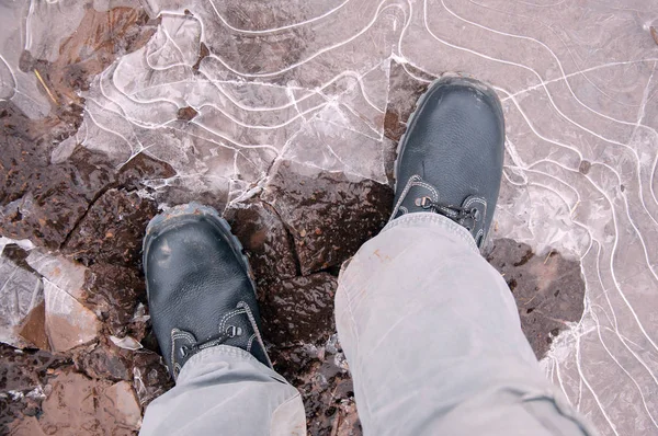 Work boots on a background of frozen ground. Work shoes